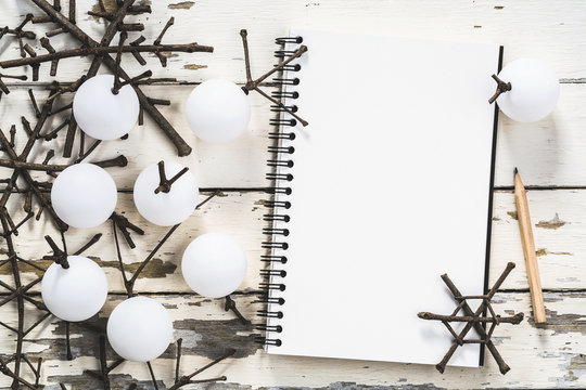 Christmas decoration background, Overhead view of notebook, pencil and Handmade christmas ornaments on rustic wood table, Winter and New year concept