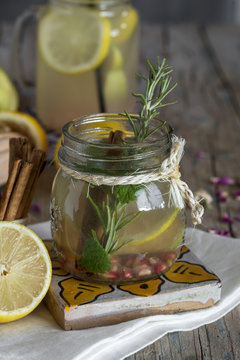 Lemonade with fresh lemon on wooden background