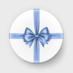 White Round Gift Box with Light Blue Satin Bow and Ribbon Close up Isolated on Background
