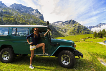 beautiful woman tourist near a car 4x4 on mountain © czamfir
