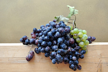 dark grapes bunch on wood