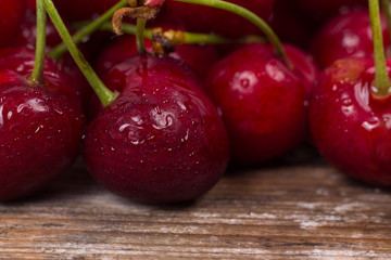 Fresh red Cherries on wooden table macro background