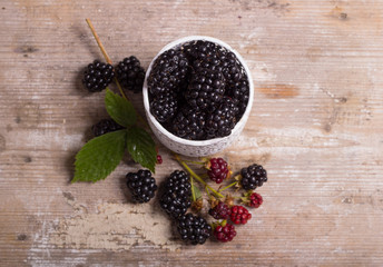 Fototapeta na wymiar Blackberries on a wooden table and mint leaves