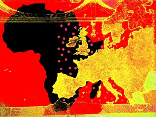 The African policy of Europe -
Behind a golden European map the map of Africa is visible in black against a red background.

