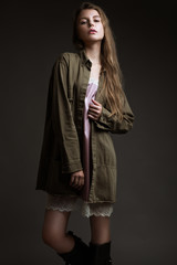 Attractive beautiful fashionable woman in everyday clothes, nude make-up, showing different poses in the studio. Beauty face and body. Test Shots.