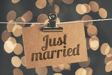 Just married sign pegged to a string with blurred bokeh lights in the background