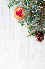 Christmas tree branches on wood background