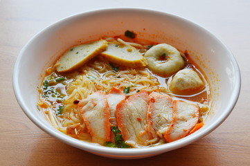 thin noodle with fish ball and red barbecue pork in spicy soup