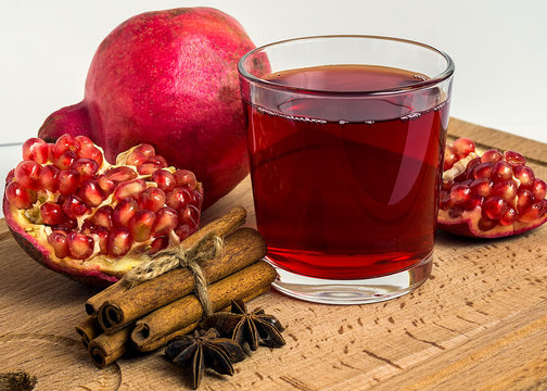 star anice, cinnamon and pomegranate tea on wooden table.