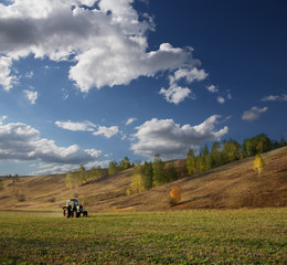 Farm tractor on the field in Europe