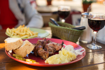 lunch at the cafe, kebab with fries and glasses of wine
