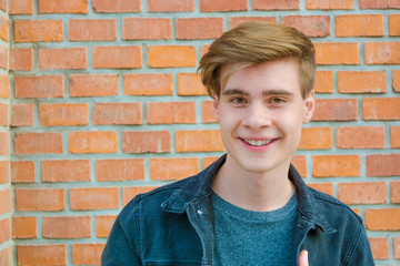 Teen boy face portrait showing expression of happiness smiling w