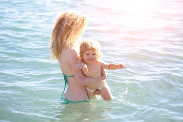 Woman in bikini with child