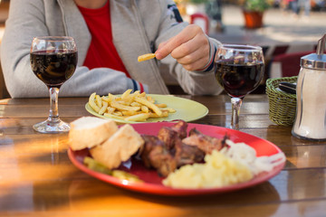 lunch at the cafe, kebab with fries and glasses of wine
