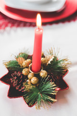 Close up on burning chrismas candle decoration - christmas, advent, celebration concept