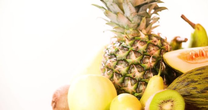 Still life fruits composition rotation 4k looped video. Tropoical food in basket isolated on white background with copy space
