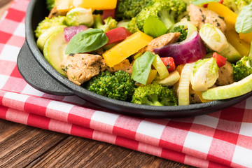 Roasted meat and vegetables on a black wooden background