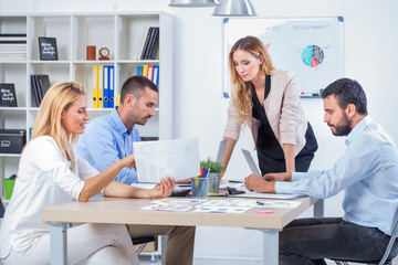 Fototapeta premium Group Of Business People Having Meeting In Office. Business partners discussing documents and ideas at meeting