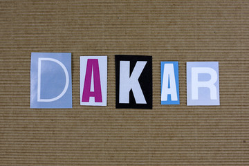 Dakar word cut from newspaper on carton background