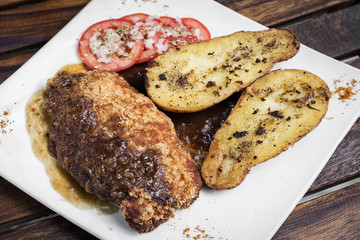 chicken schnitzel with potato and gravy meal