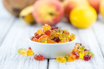 Wooden table with Gummy Bears (selective focus)