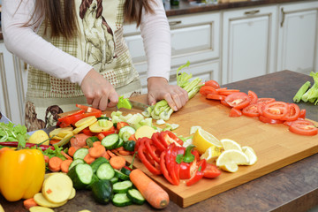 Young Woman Cooking in the kitchen. Healthy Food
