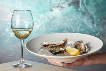 Oysters in a white plate with lemon