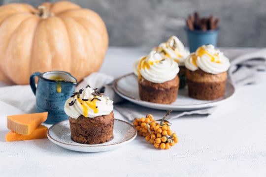 Pumpkin muffin decorated with cream cheese topping, chocolate an