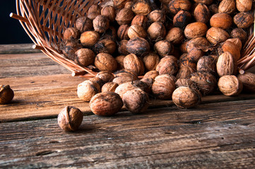 Walnuts in wicker basket. Copyspace