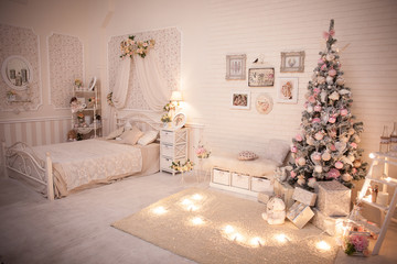 Christmas bedroom in shabby chic style. Decorated tree in cozy New Year interior design.