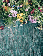 Bouquet of fresh summer flowers on the blue wooden grunge desk. Mock up for greeting cards, holiday postcards, invintation in vintage hipster eco rustic style with copy space