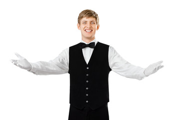 Young happy smiling waiter gesturing welcome