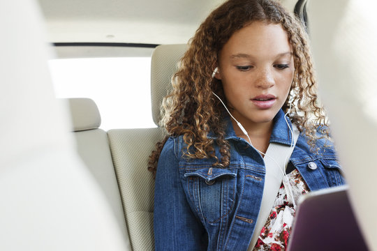 Teenager Listening Music While Sitting In Car