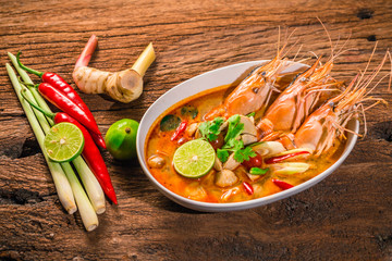 Tom Yum Goong Thai hot spicy soup shrimp  with lemon grass,lemon,galangal on wooden background...