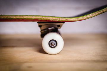 skateboard with white wheels and black trucks on the floor in the skate park © superelaks