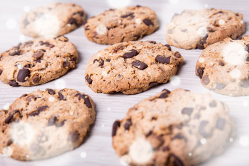 christmas concept - close up of chocolate chip cookies on wooden