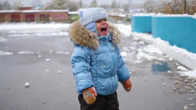 child have fun playing with snow winter