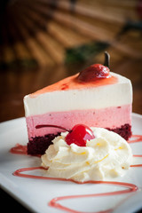 Strawberry cheesecake on wooden background