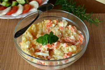 Fresh Homemade Potato Salad with Eggs and Carrots On Glass Bowl