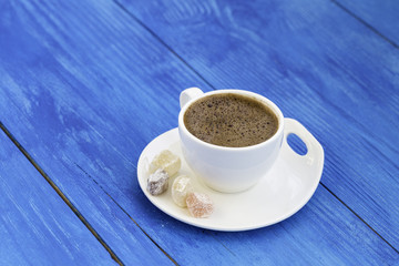 Turkish coffee with delight on wooden background