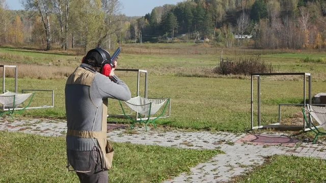 Rifleman shoots the target. Slow motion.