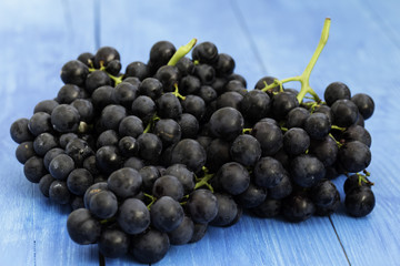 Black grapes on wooden background