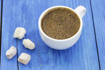 Turkish coffee with delight on wooden background