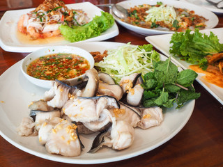 Dip fish fillets poached with seafood sauce.