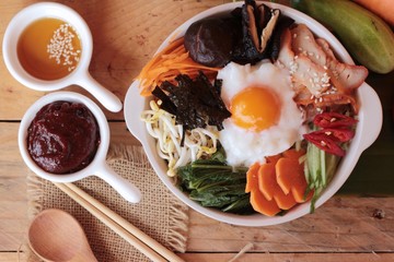 Bibimbap korean food is delicious on wood background.