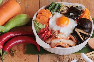 Bibimbap korean food is delicious on wood background.