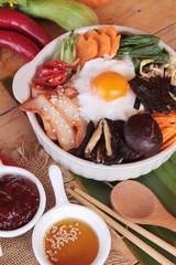 Bibimbap korean food is delicious on wood background.