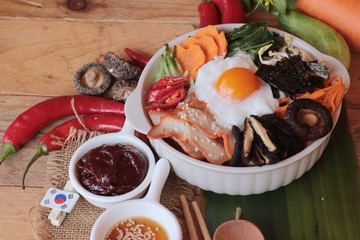 Bibimbap korean food is delicious on wood background.