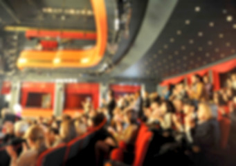 Audience in a theater, on a concert and applauding blurred