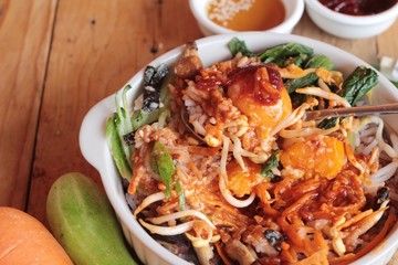 Bibimbap korean food is delicious on wood background.